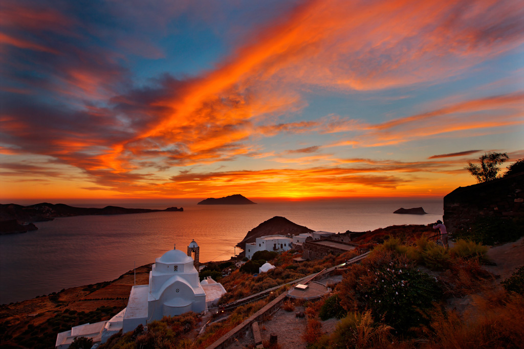 MILOS ISLAND, GREECE. Sunset view from Kastro (literally "castle"), next to Plaka village. The church in the foreground is named Panagia Thalassitra.